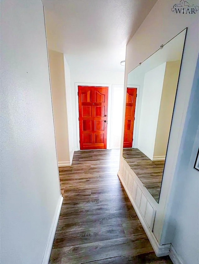 mudroom featuring wood finished floors and baseboards