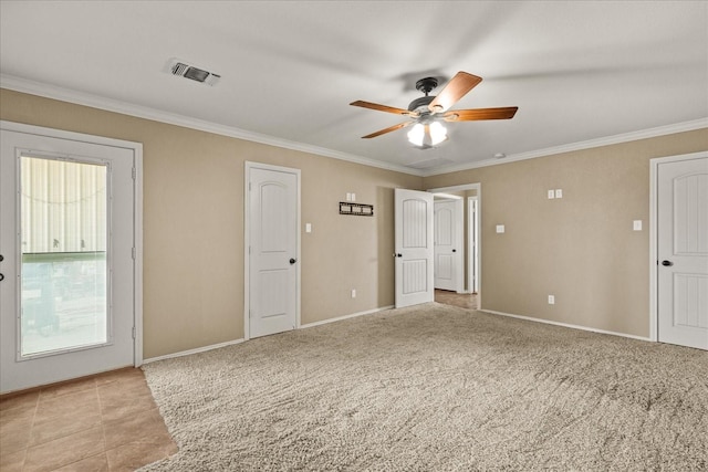 empty room with light carpet, baseboards, visible vents, a ceiling fan, and crown molding