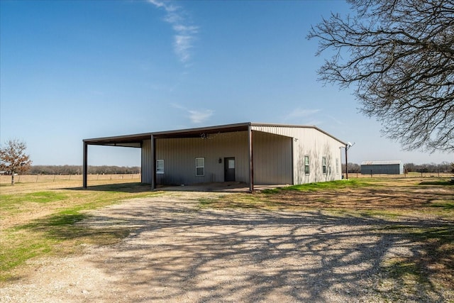 view of pole building featuring a rural view and driveway