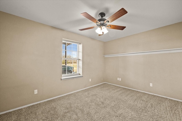 empty room with carpet floors, baseboards, and a ceiling fan