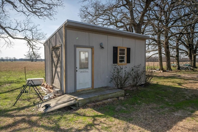 view of outbuilding with a rural view and an outdoor structure