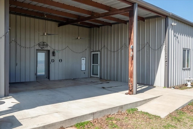 entrance to property featuring a ceiling fan and a patio