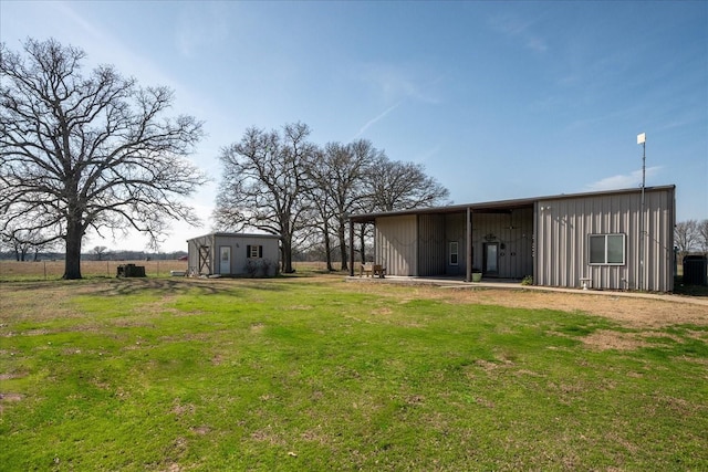 view of yard featuring central air condition unit and an outbuilding