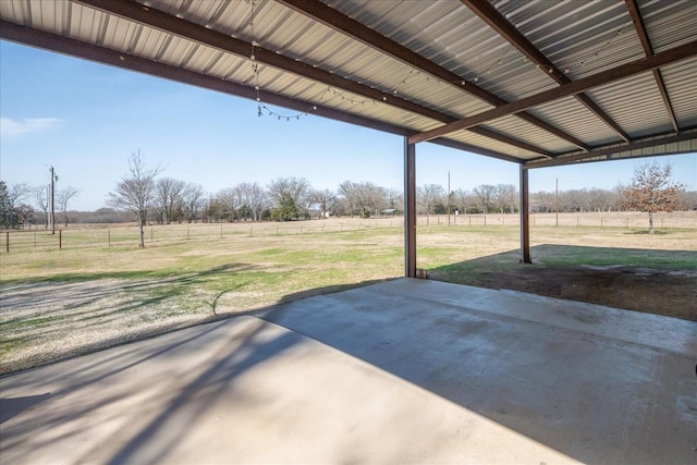 view of patio / terrace featuring a rural view and fence