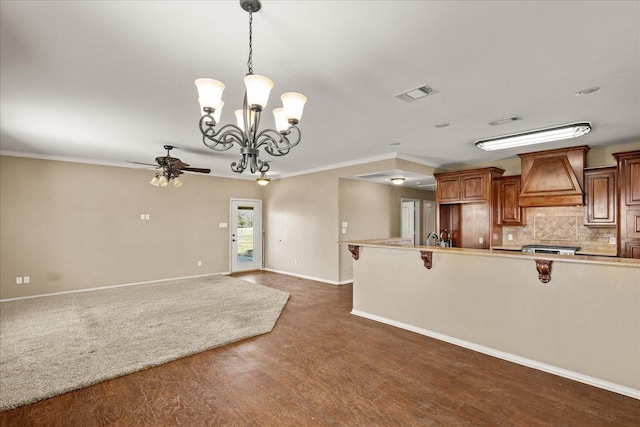 kitchen featuring premium range hood, visible vents, open floor plan, light countertops, and pendant lighting