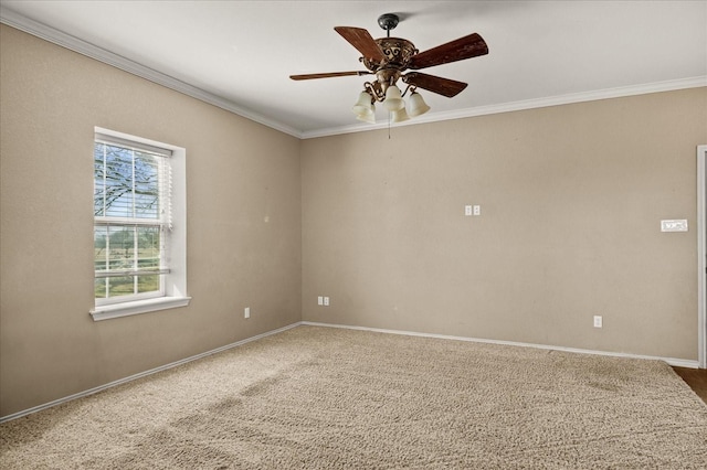 unfurnished room with carpet, baseboards, ornamental molding, and a ceiling fan