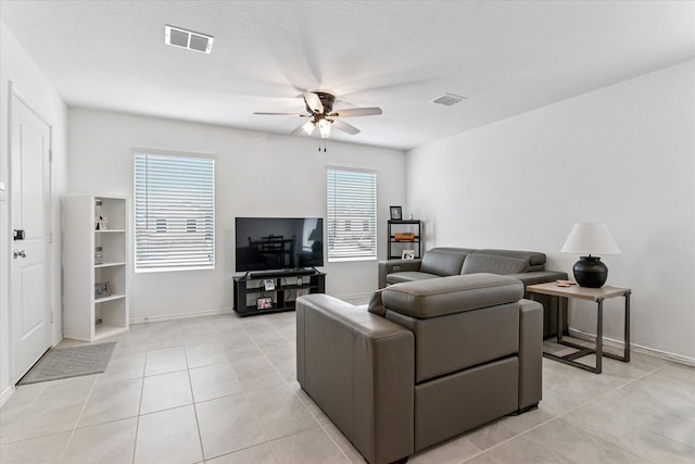 living room featuring ceiling fan, light tile patterned floors, and visible vents