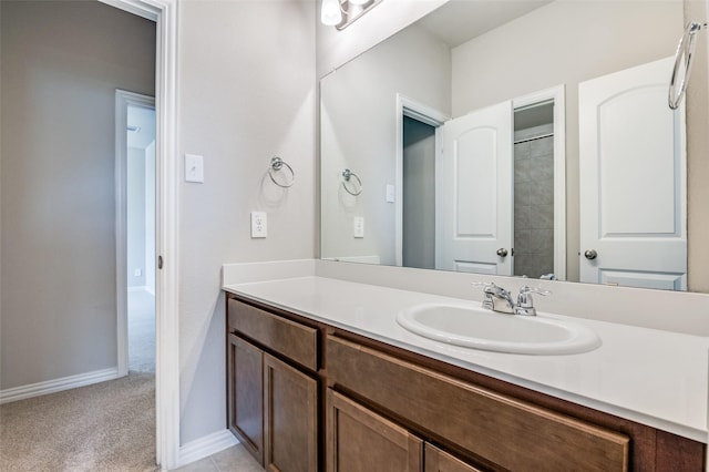 full bath featuring vanity and baseboards