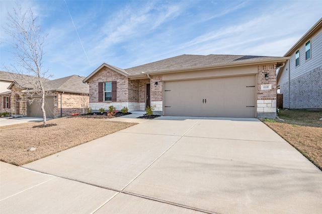 single story home featuring a garage, concrete driveway, and brick siding