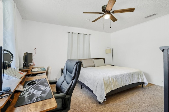 bedroom with carpet, visible vents, ceiling fan, and a textured ceiling