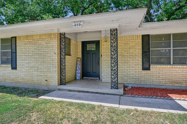 property entrance featuring brick siding