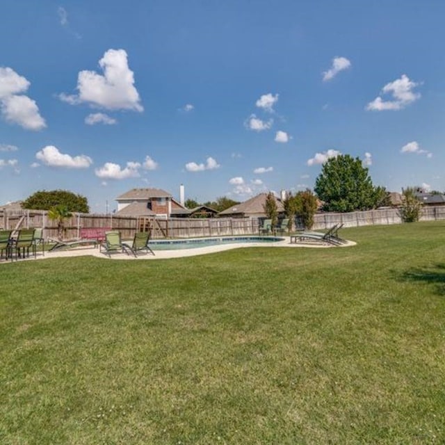 view of yard with fence and a fenced in pool