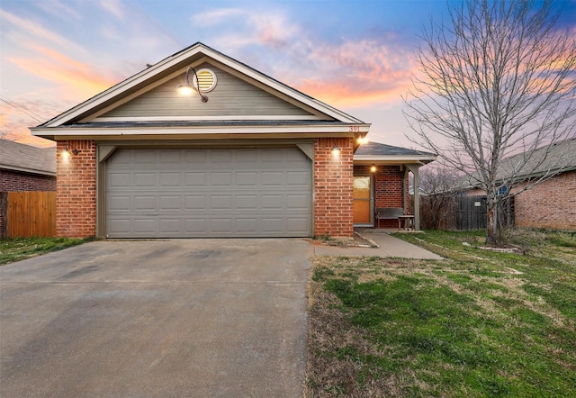 ranch-style home with concrete driveway, brick siding, an attached garage, and fence