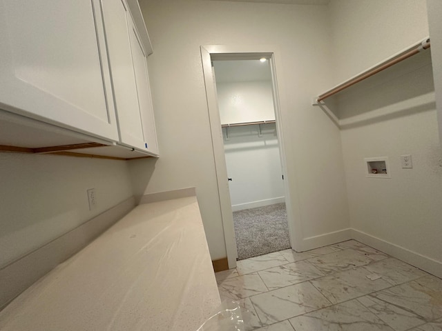 1045 Woodland Rd, Weatherford, TX 76088 - laundry room with washer hookup, cabinet space, light marble finish floors, and baseboards