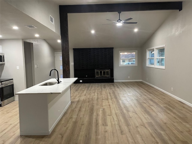 living area featuring visible vents, baseboards, a brick fireplace, beam ceiling, and light wood finished floors