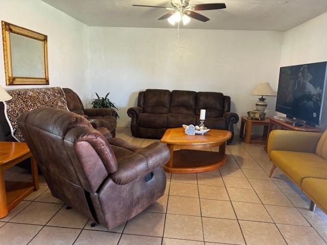 living room featuring a ceiling fan and light tile patterned flooring