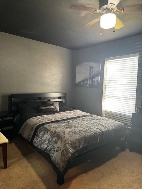 carpeted bedroom featuring a ceiling fan