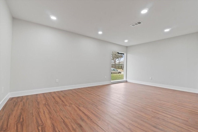 empty room featuring recessed lighting, baseboards, visible vents, and light wood finished floors