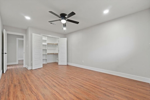 unfurnished bedroom with baseboards, visible vents, a ceiling fan, light wood-type flooring, and a closet