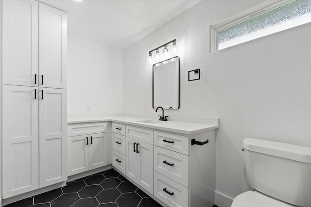 bathroom with vanity, toilet, and tile patterned floors