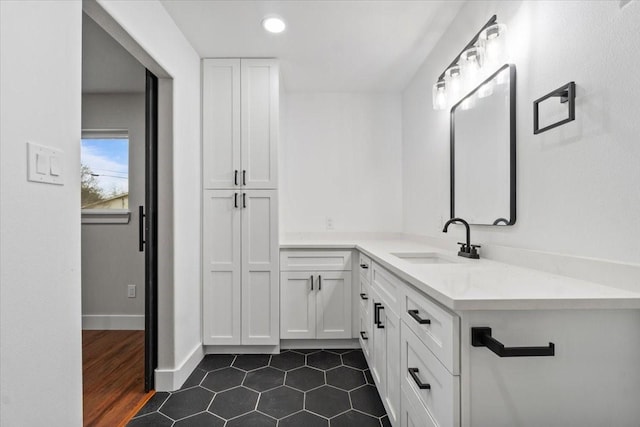 bathroom with recessed lighting, tile patterned flooring, vanity, and baseboards