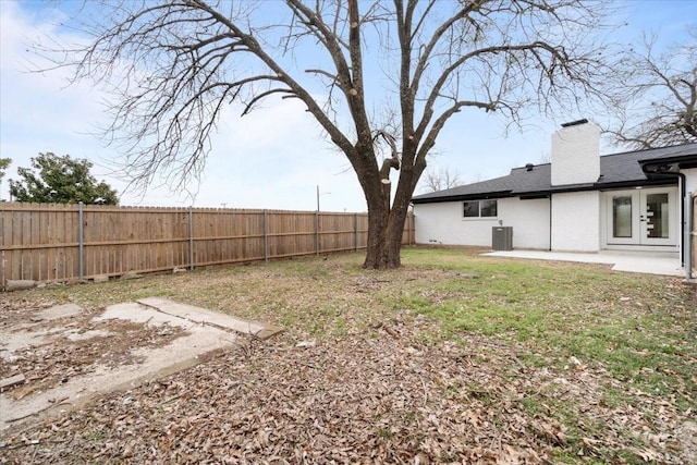 view of yard featuring a patio area, a fenced backyard, and central AC