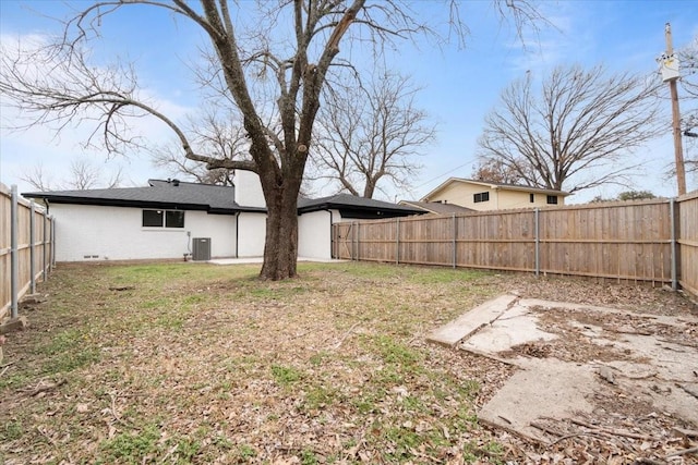 view of yard featuring a fenced backyard and central air condition unit