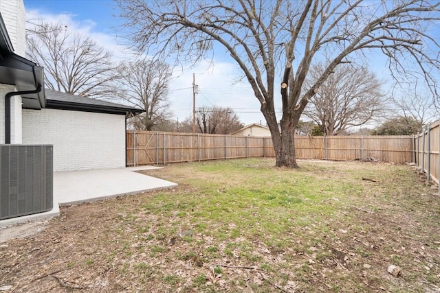 view of yard with a fenced backyard, a patio area, and cooling unit