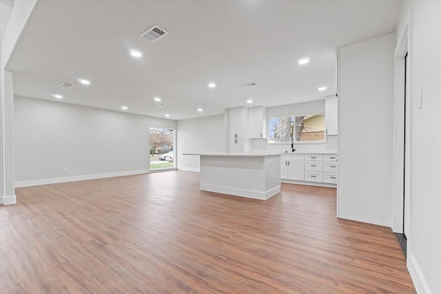 unfurnished living room featuring recessed lighting, visible vents, and light wood-style floors