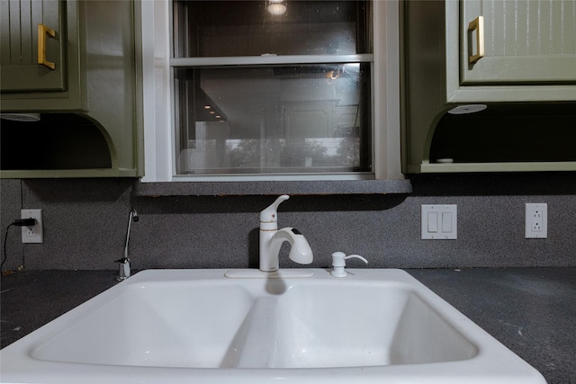 room details with backsplash, a sink, and light countertops