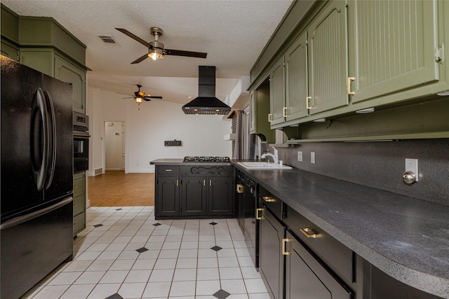 kitchen featuring freestanding refrigerator, green cabinetry, and island range hood