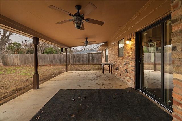 view of patio / terrace with ceiling fan and fence