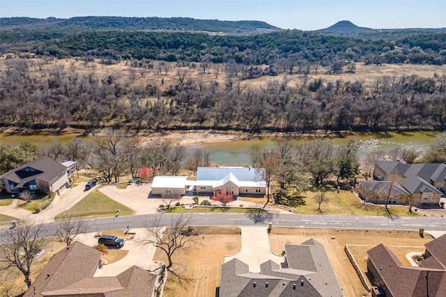 drone / aerial view with a water and mountain view