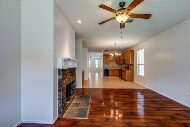 8860 Noontide Dr, Fort Worth, TX 76179 - unfurnished living room featuring a ceiling fan, light wood-type flooring, a high end fireplace, plenty of natural light, and recessed lighting