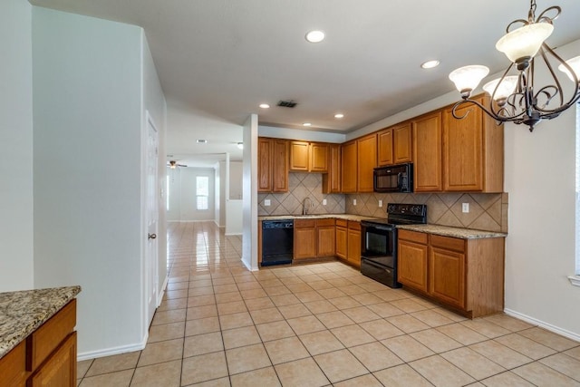 8860 Noontide Dr, Fort Worth, TX 76179 - kitchen with black appliances, a chandelier, light tile patterned floors, tasteful backsplash, and light stone counters