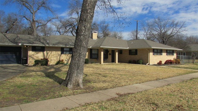 ranch-style house featuring a front yard, brick siding, and a chimney