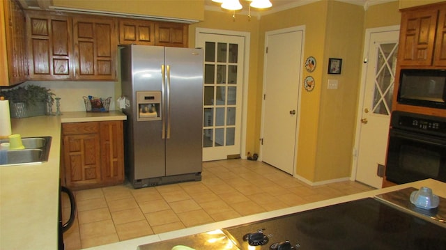 kitchen featuring brown cabinets, black appliances, ornamental molding, and light countertops