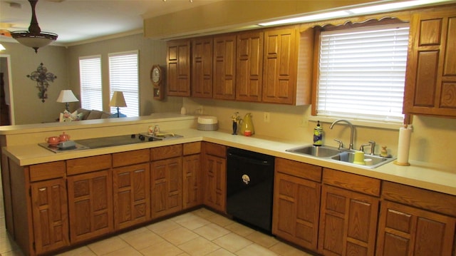 kitchen with light countertops, a sink, and black appliances