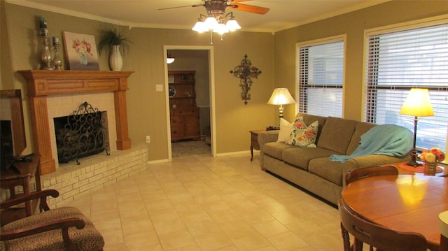 living area featuring a brick fireplace, crown molding, baseboards, and ceiling fan