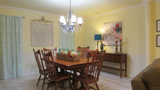 dining room with baseboards, ornamental molding, and a notable chandelier