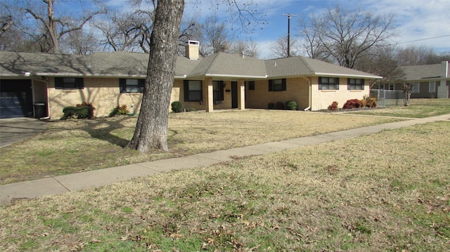 ranch-style house with a shingled roof, brick siding, a chimney, and a front lawn