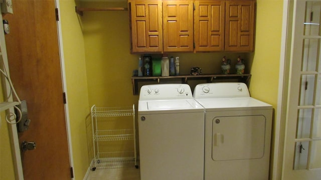 clothes washing area with cabinet space and separate washer and dryer