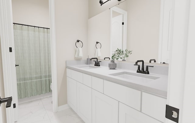 full bathroom featuring marble finish floor, double vanity, a sink, and shower / bath combo with shower curtain