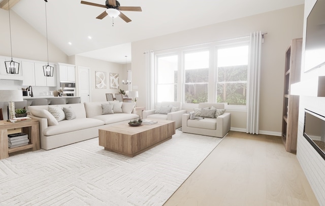 living area with a glass covered fireplace, ceiling fan, light wood-style flooring, high vaulted ceiling, and recessed lighting