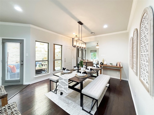 dining area featuring ornamental molding, dark wood-style flooring, visible vents, and baseboards