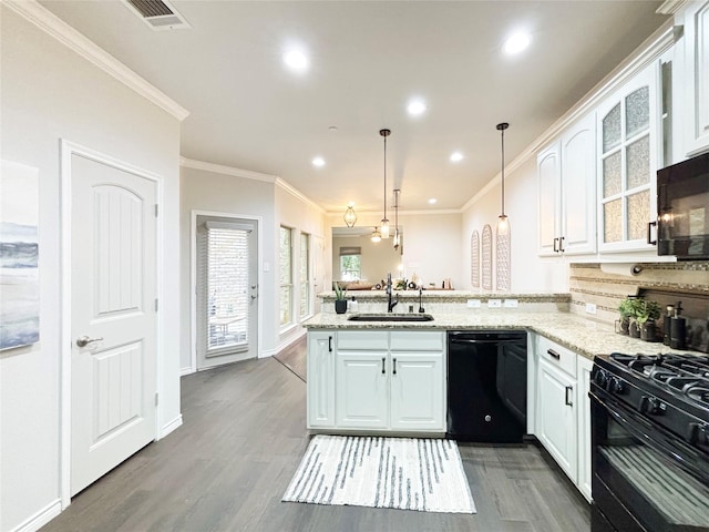 kitchen featuring black appliances, visible vents, white cabinets, and a sink