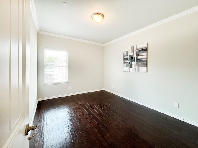 unfurnished room with dark wood-style floors, ornamental molding, and baseboards