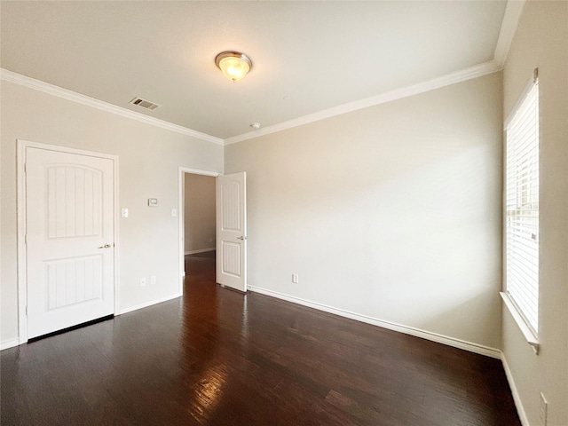 unfurnished room with dark wood-style floors, crown molding, visible vents, and a wealth of natural light