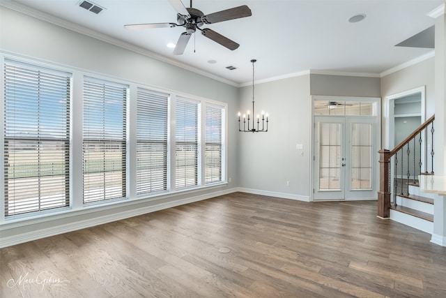 unfurnished room featuring ornamental molding, visible vents, stairway, and wood finished floors