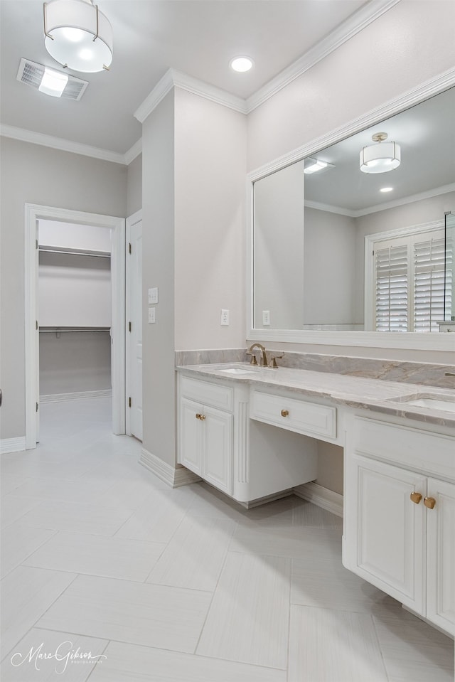 full bathroom with a spacious closet, vanity, visible vents, and crown molding